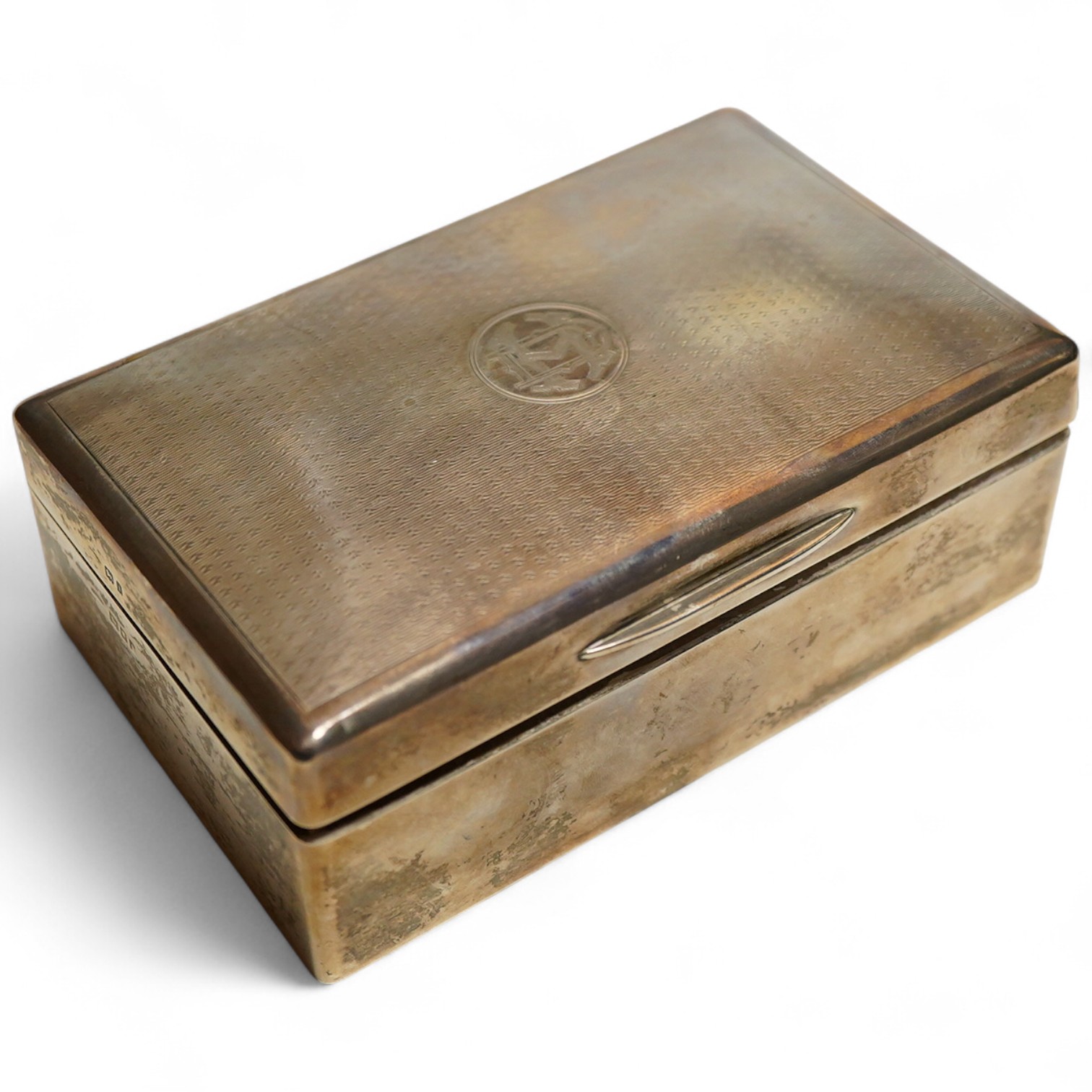 A George V silver table cigarette box with engine turned lid, London, 1924, makers mark rubbed, cedar lined with division, initialled length 14cm.